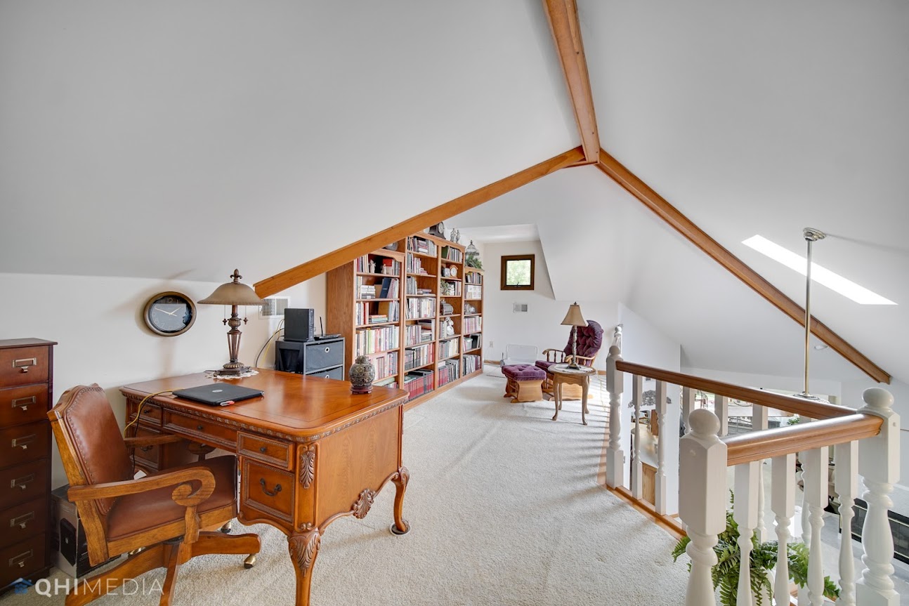 Remodeled attic with an office and personal library.